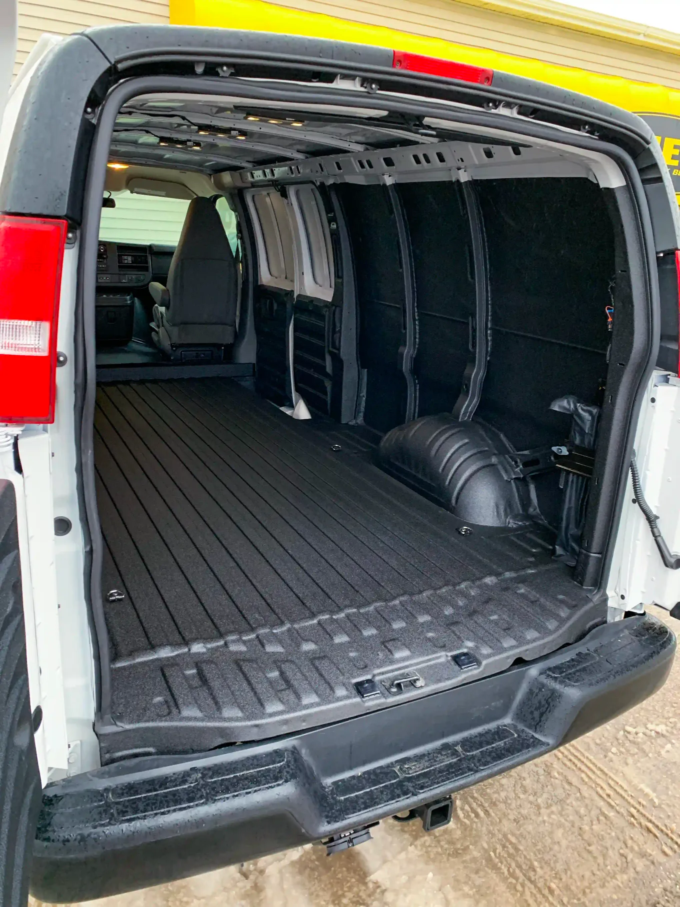 Cargo van interior floor protected with black spray-on liner